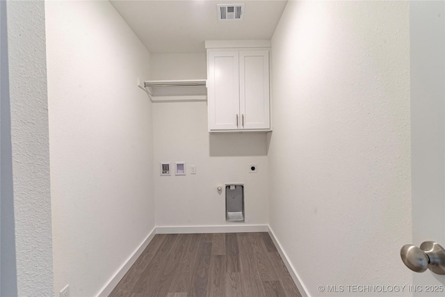 laundry room with gas dryer hookup, cabinets, dark hardwood / wood-style floors, washer hookup, and hookup for an electric dryer