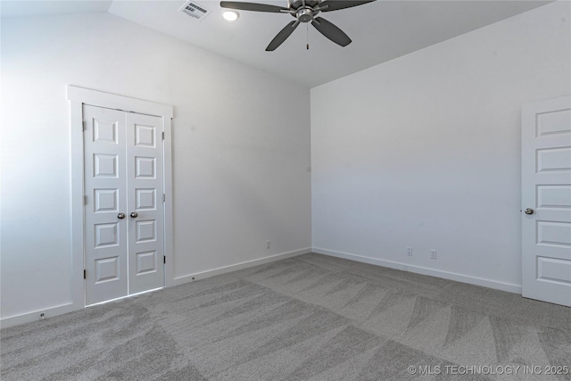 carpeted empty room with lofted ceiling and ceiling fan