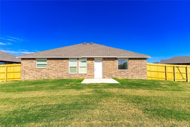 back of property featuring a patio area and a lawn