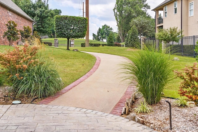 view of home's community with a lawn