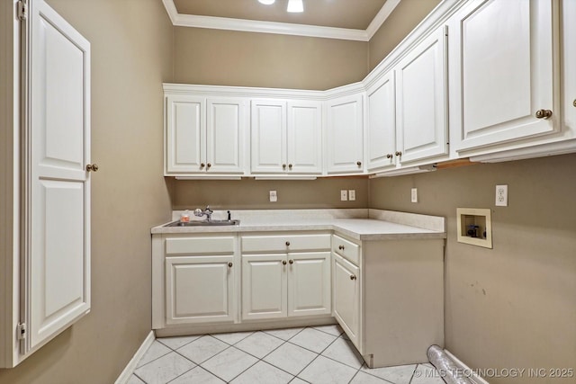 laundry room featuring sink, cabinets, ornamental molding, light tile patterned floors, and hookup for a washing machine