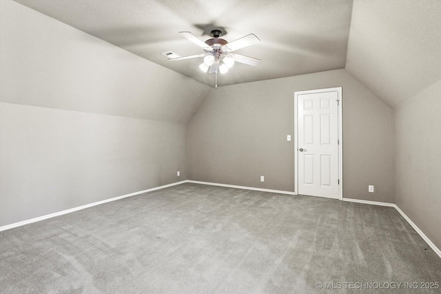 additional living space featuring lofted ceiling, ceiling fan, and carpet