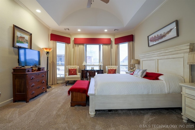 bedroom featuring crown molding, vaulted ceiling, light colored carpet, and a tray ceiling