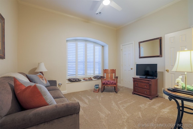 living room with ornamental molding, light colored carpet, and ceiling fan