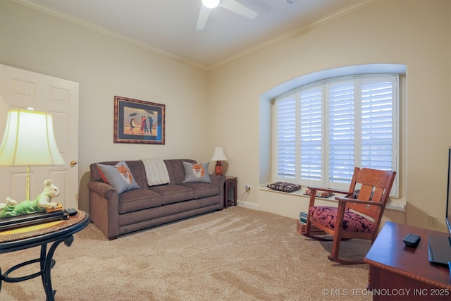 living room featuring ornamental molding, ceiling fan, and carpet