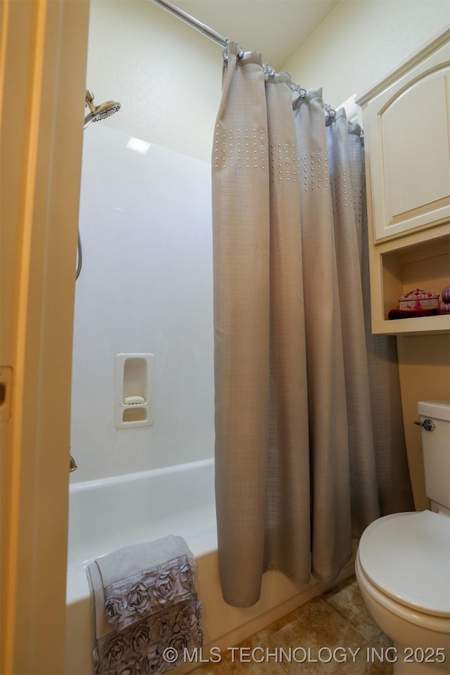 bathroom featuring shower / tub combo, toilet, and tile patterned flooring