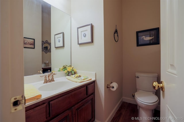 bathroom featuring vanity, toilet, and hardwood / wood-style floors