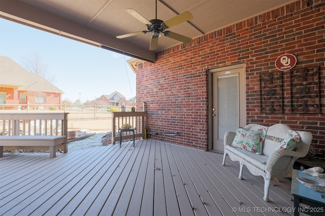 wooden terrace featuring ceiling fan