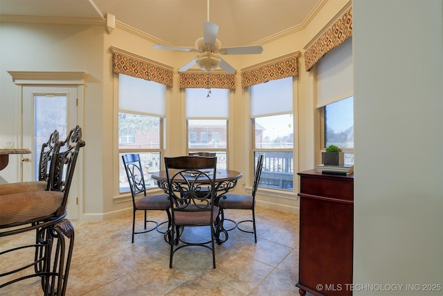 tiled dining room featuring crown molding and ceiling fan