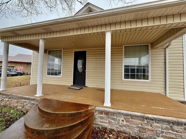 view of exterior entry with a porch