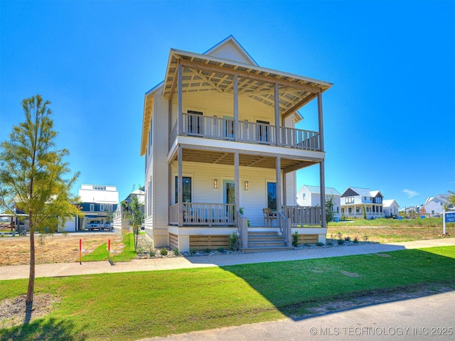 view of front of home with a porch, a balcony, and a front yard