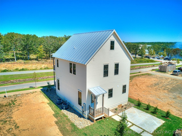 rear view of property with central AC