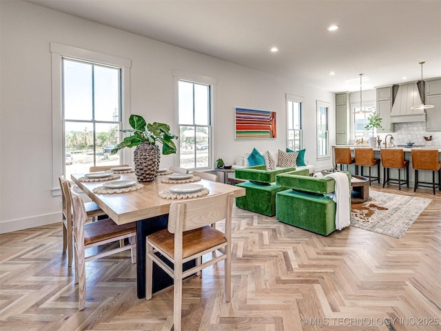 dining space with light parquet flooring