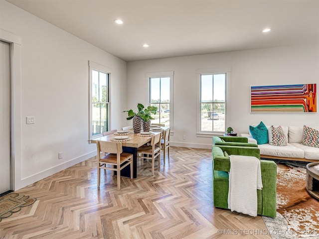 dining area featuring a healthy amount of sunlight and light parquet flooring