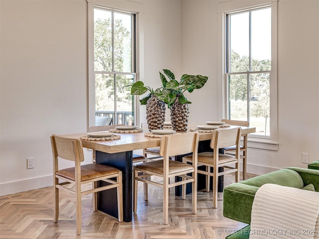dining area with plenty of natural light and light parquet floors