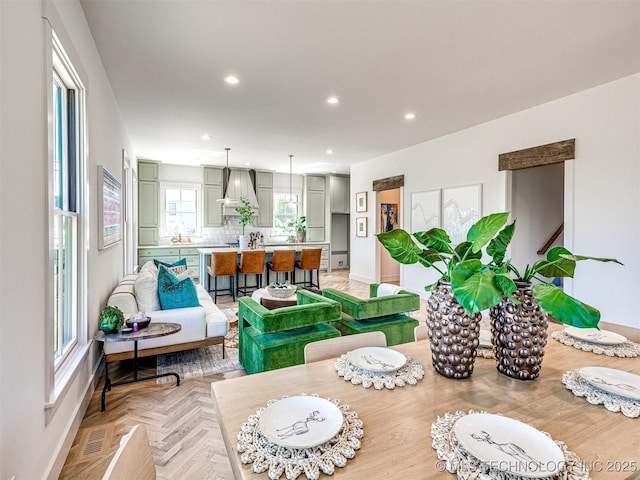 dining space featuring light parquet floors