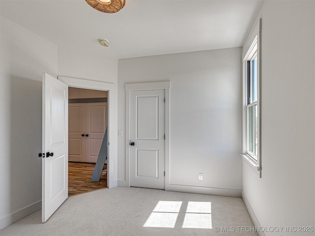 carpeted bedroom with multiple windows