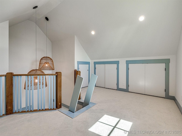 additional living space with vaulted ceiling and light colored carpet