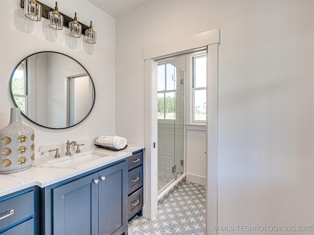 bathroom featuring vanity and a shower with shower door