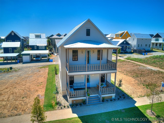view of front of property featuring a garage, a balcony, and covered porch