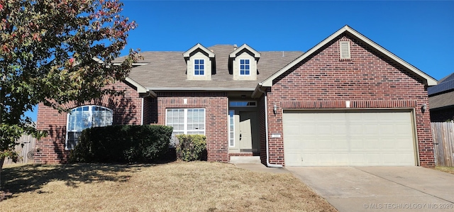 view of front of house with a garage and a front yard