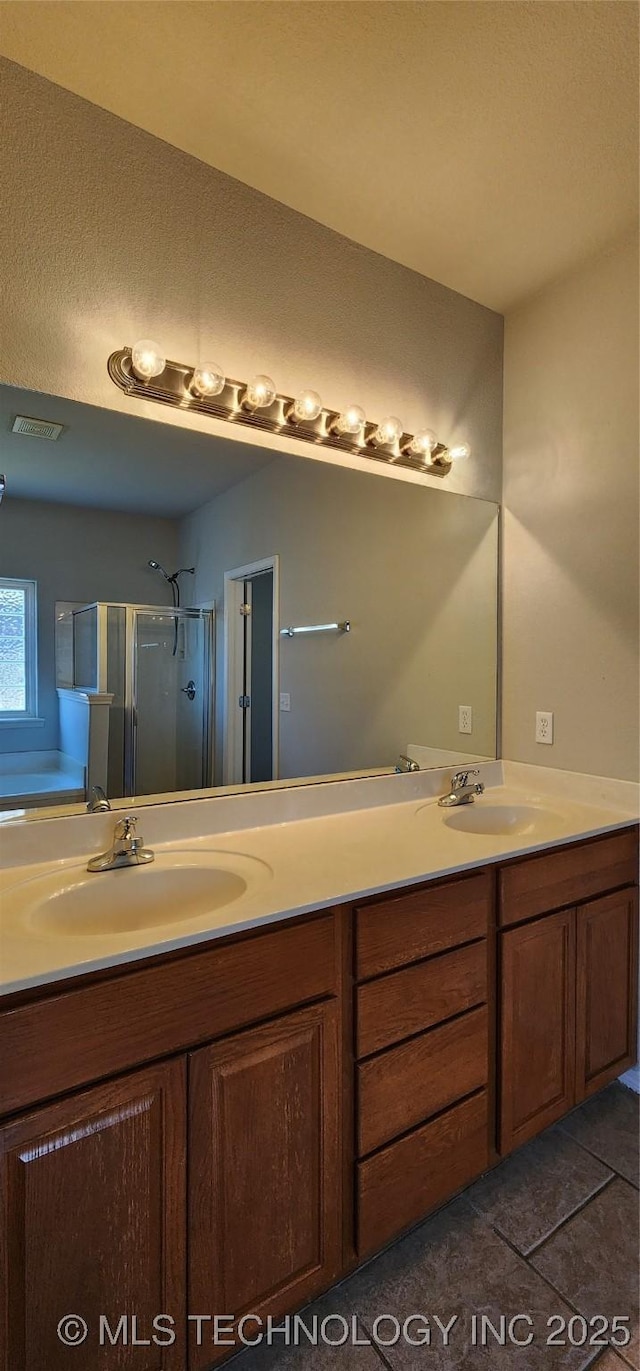 bathroom featuring independent shower and bath, vanity, and tile patterned floors