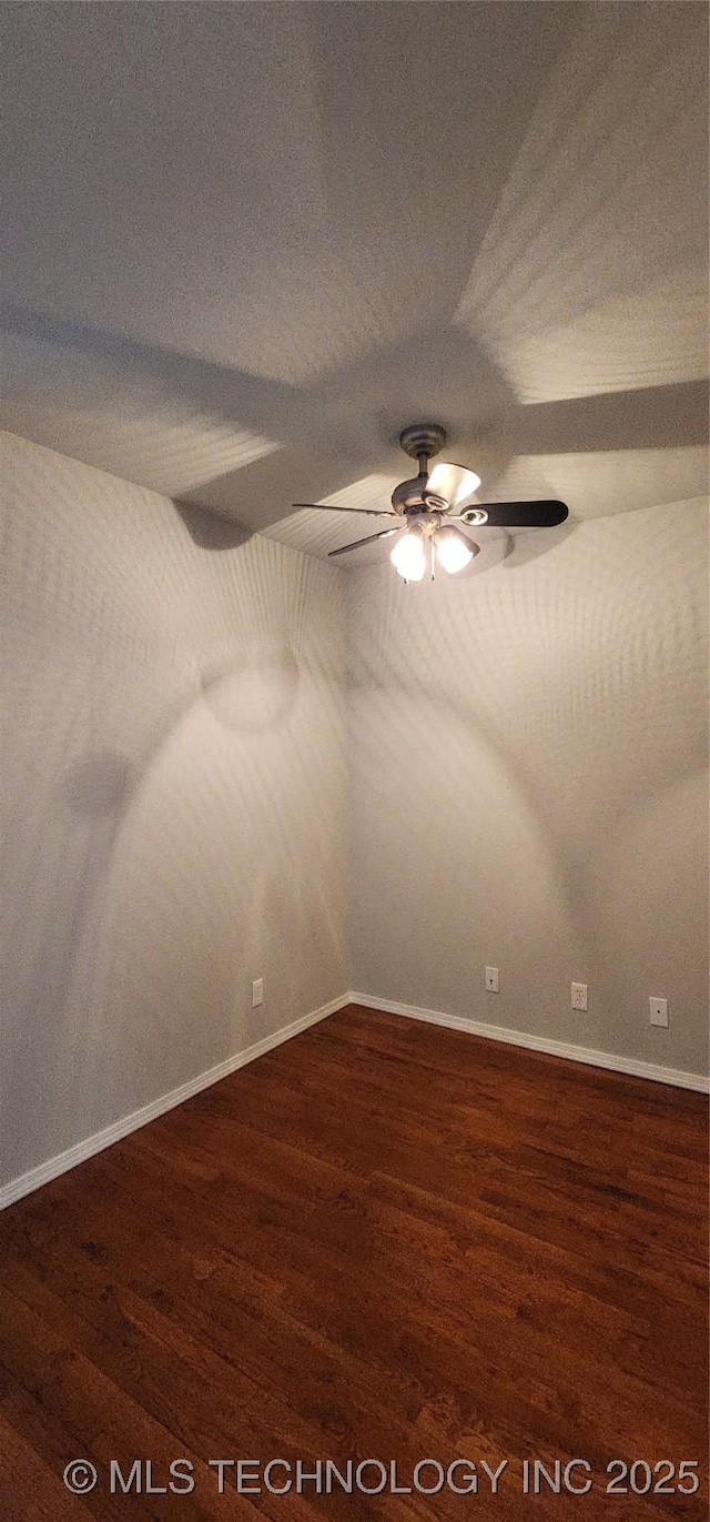 spare room featuring dark hardwood / wood-style floors and ceiling fan