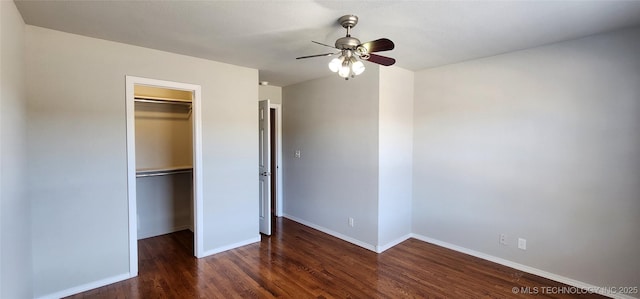 unfurnished bedroom with ceiling fan, a walk in closet, dark hardwood / wood-style floors, and a closet