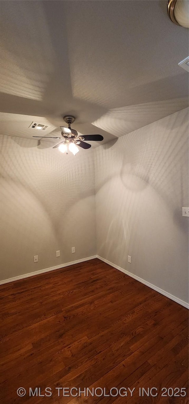 empty room featuring dark hardwood / wood-style floors and ceiling fan