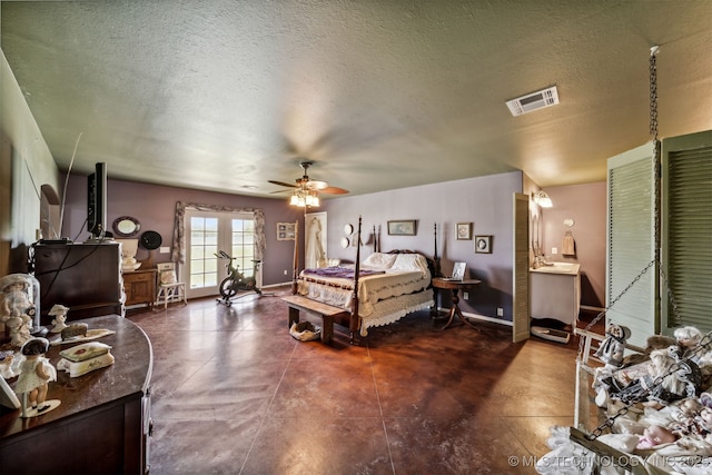 bedroom with ceiling fan and a textured ceiling