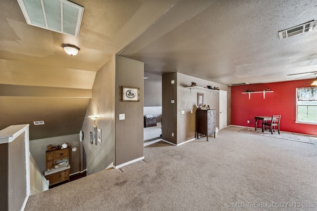 interior space with a textured ceiling and carpet