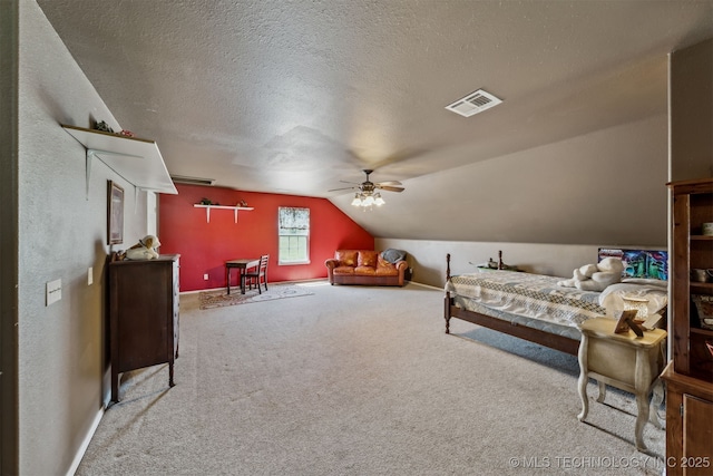 carpeted bedroom featuring vaulted ceiling and a textured ceiling