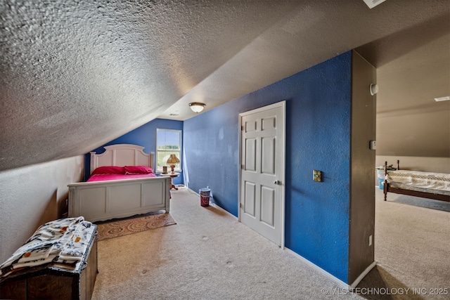 carpeted bedroom with vaulted ceiling and a textured ceiling