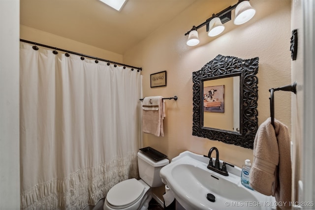 bathroom featuring sink and toilet