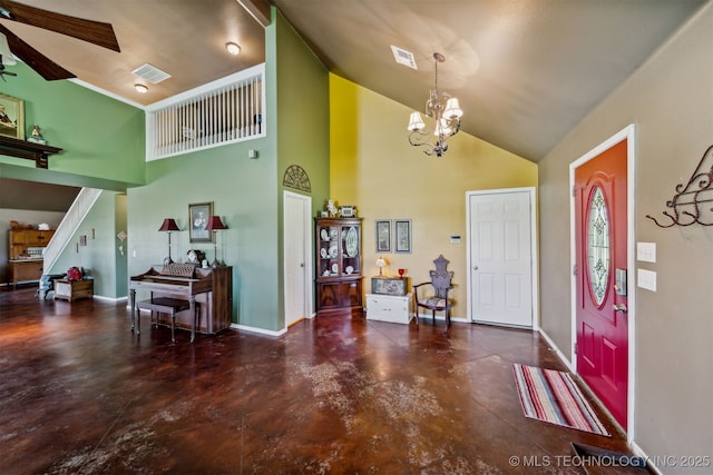 entrance foyer with ceiling fan with notable chandelier and high vaulted ceiling