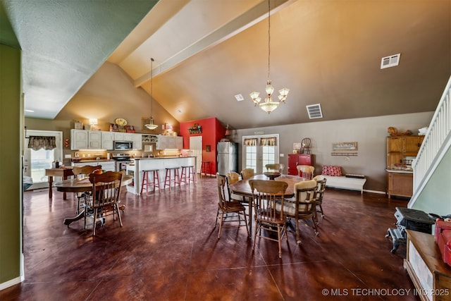 dining space featuring an inviting chandelier and high vaulted ceiling