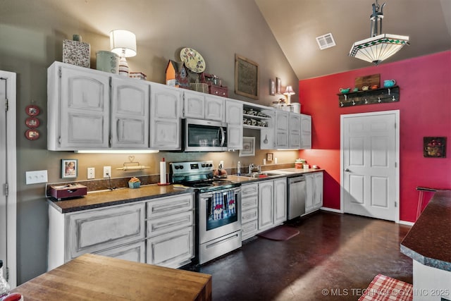 kitchen with white cabinetry, high vaulted ceiling, appliances with stainless steel finishes, and sink