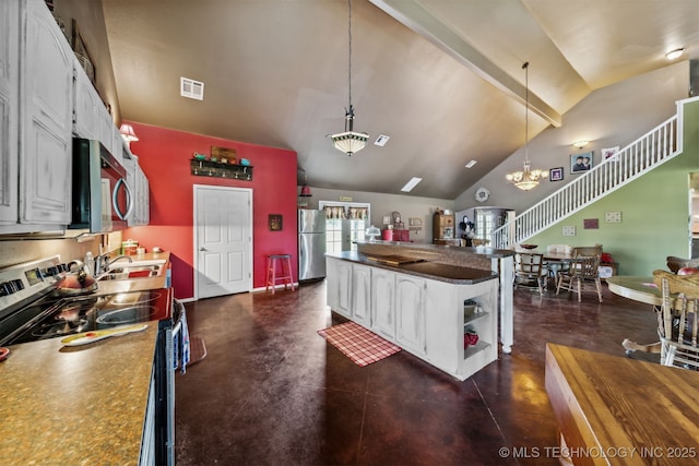 kitchen featuring lofted ceiling, white cabinetry, an inviting chandelier, stainless steel appliances, and decorative light fixtures