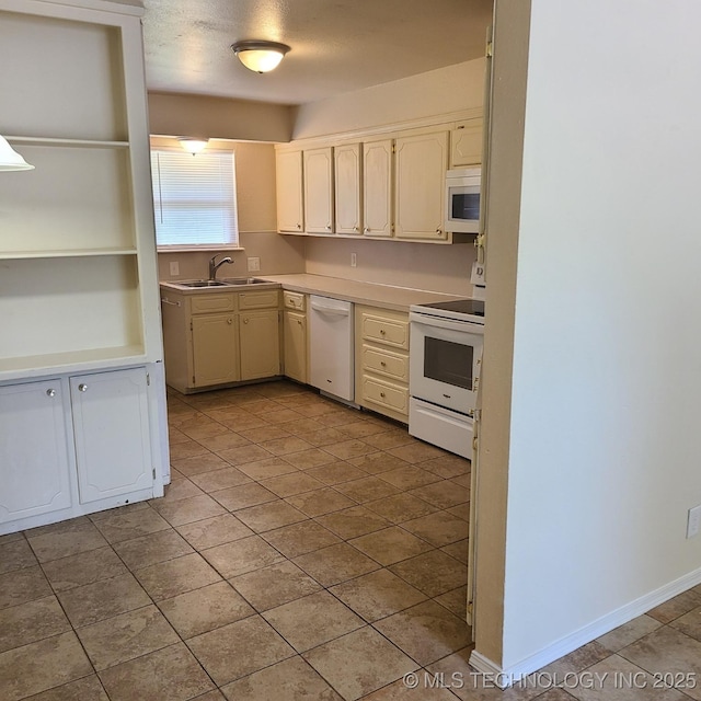 kitchen with white appliances, sink, and a textured ceiling