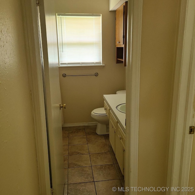 bathroom with vanity, tile patterned flooring, and toilet