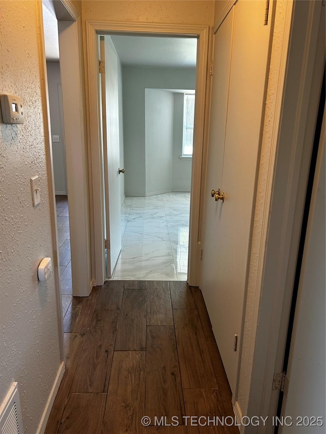 corridor featuring hardwood / wood-style flooring