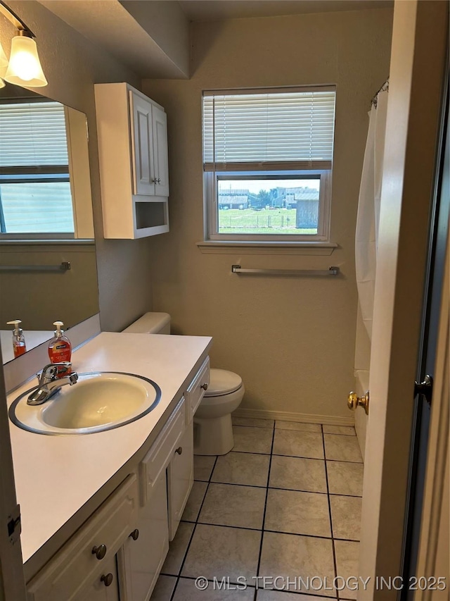 bathroom with vanity, toilet, and tile patterned flooring