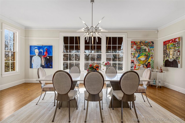 dining room with crown molding, a chandelier, and light wood-type flooring