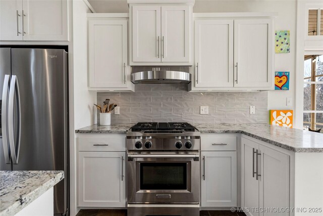 kitchen with white cabinetry, tasteful backsplash, range hood, and appliances with stainless steel finishes