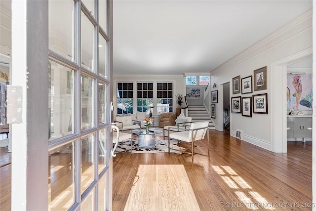 living room featuring ornamental molding and wood-type flooring