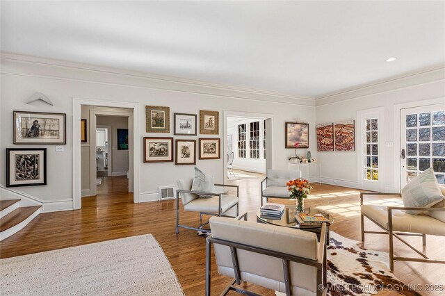 living room with crown molding and hardwood / wood-style floors