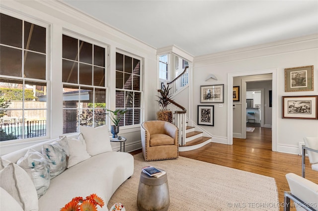 living room featuring hardwood / wood-style floors and ornamental molding