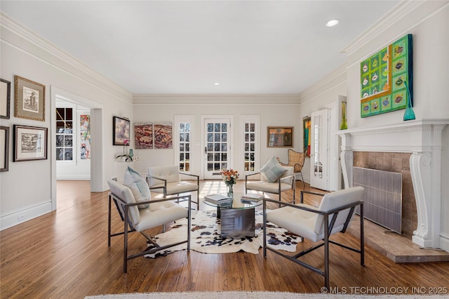 living room featuring hardwood / wood-style floors, crown molding, and plenty of natural light