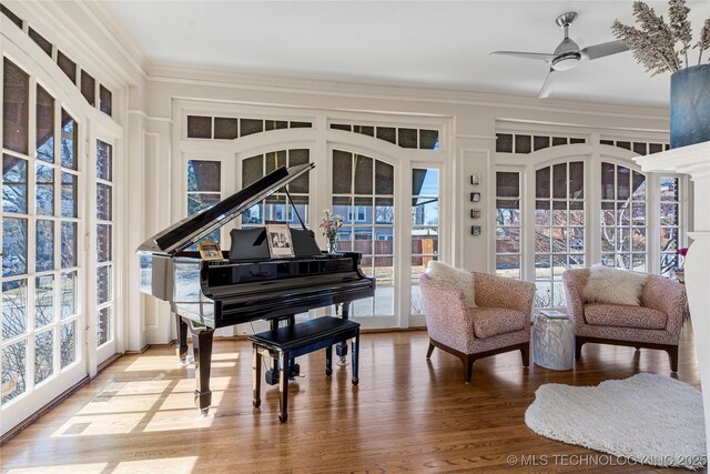 sitting room with crown molding, ceiling fan, and hardwood / wood-style flooring