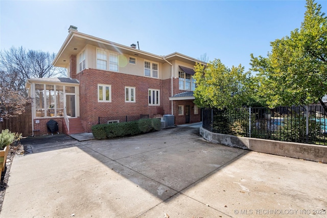 back of house featuring a sunroom and central AC unit